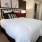 a bed with red pillows