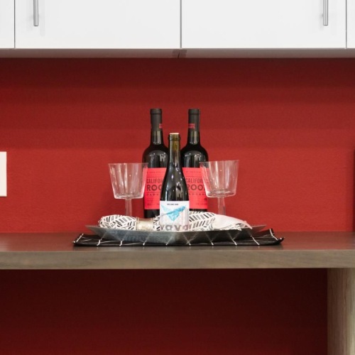 Spacious kitchens with thoughtful details a counter with wine glasses and bottles on it