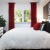 a bed with red curtains