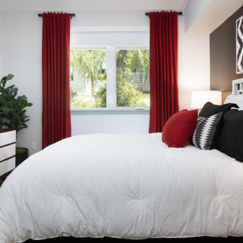 Relax and recharge in beautiful and spacious bedrooms a bed with red curtains