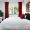 bedroom with bed and red curtains