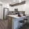 a kitchen with a bar stool and a refrigerator